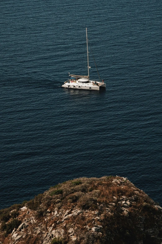 a boat in the ocean with a mountain in the background