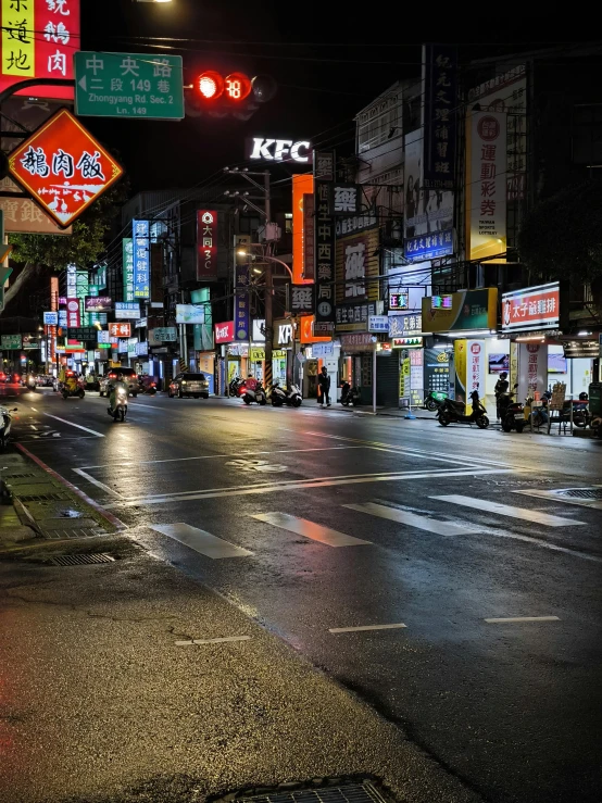 an empty city street with traffic lights and signs