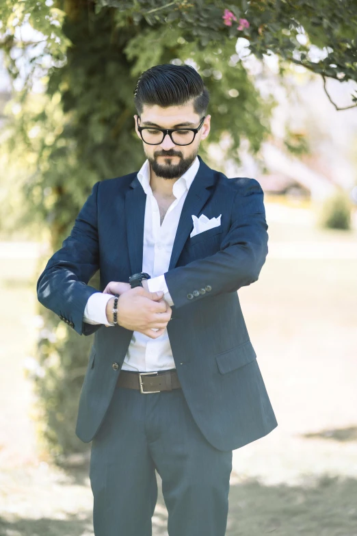 a man with a beard wearing glasses and a jacket