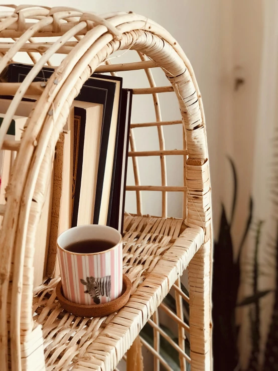 a wicker shelf with a cup of coffee sitting on it