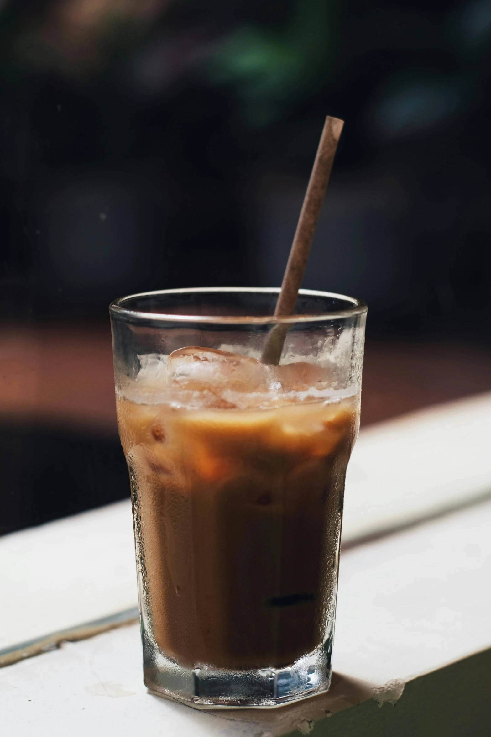 a beverage glass sitting on top of a counter