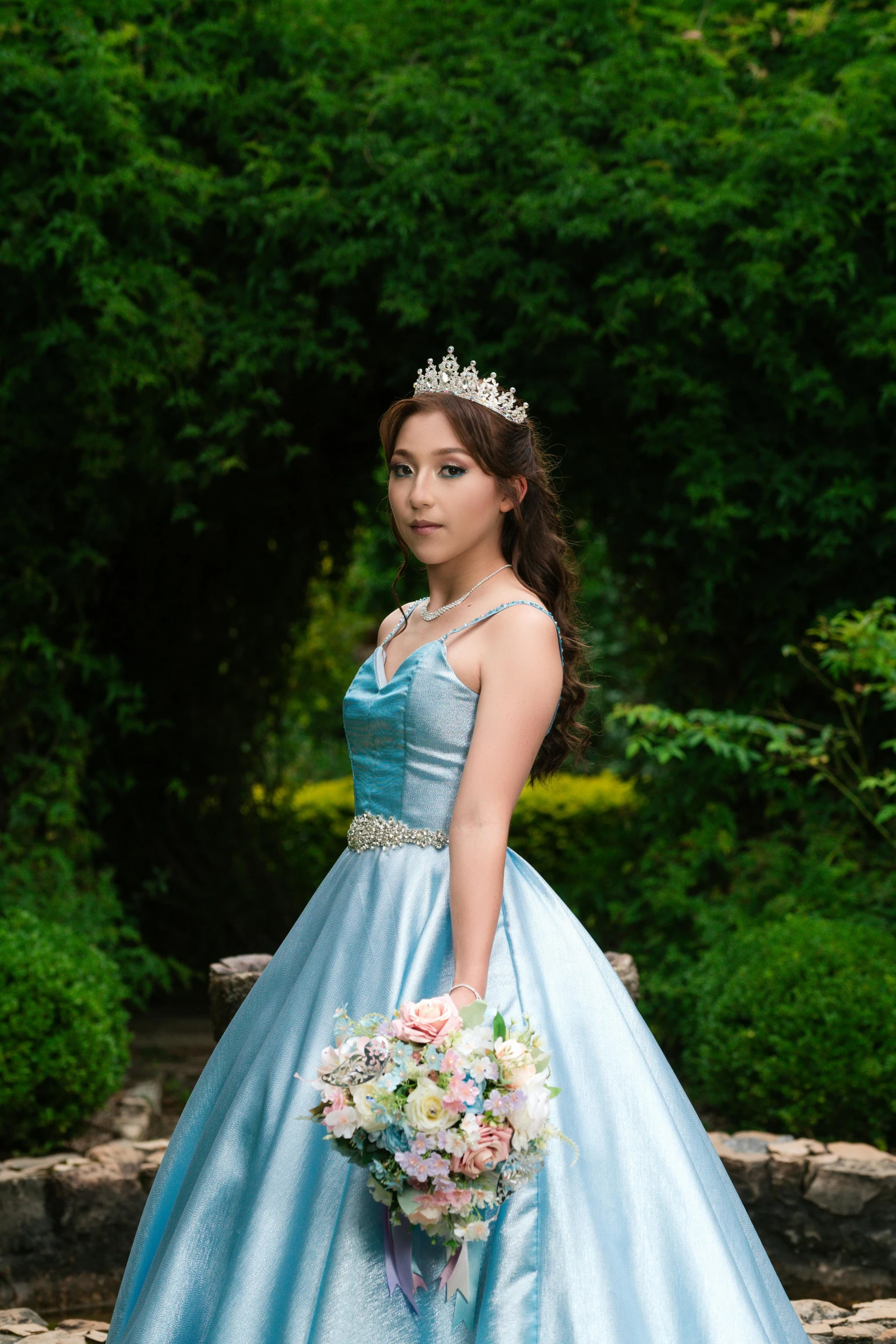 a bride poses with a wedding bouquet in front of her