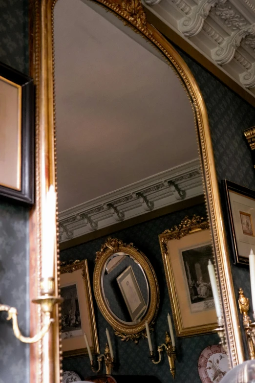 a very ornate mirror hanging in the corner of a room