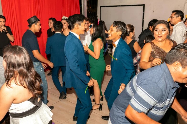 a group of people dancing and drinking at a party
