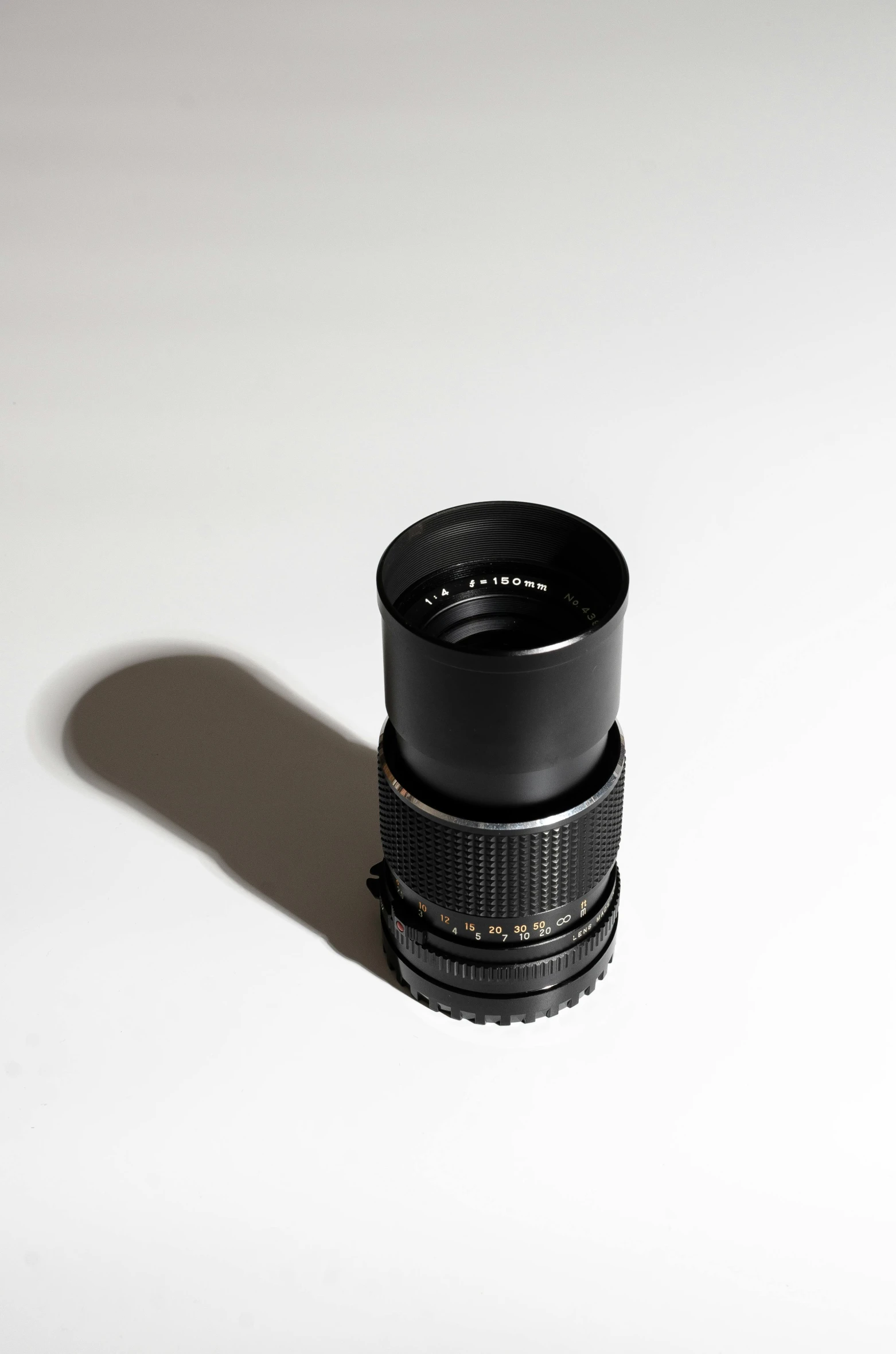 a camera lens on the floor with white background