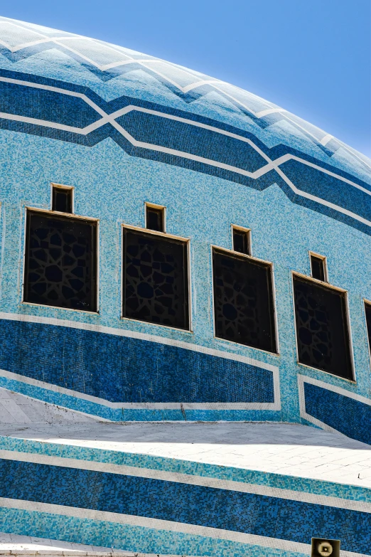 some windows and a blue building with large windows