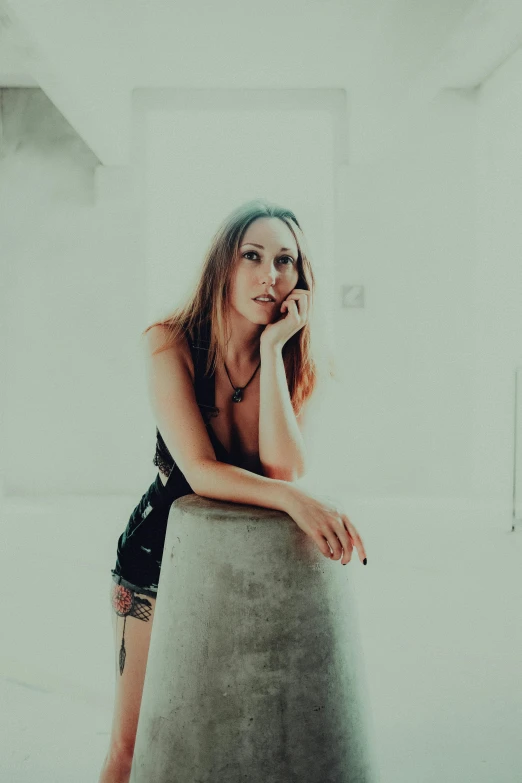 a beautiful woman sitting down talking on a cell phone