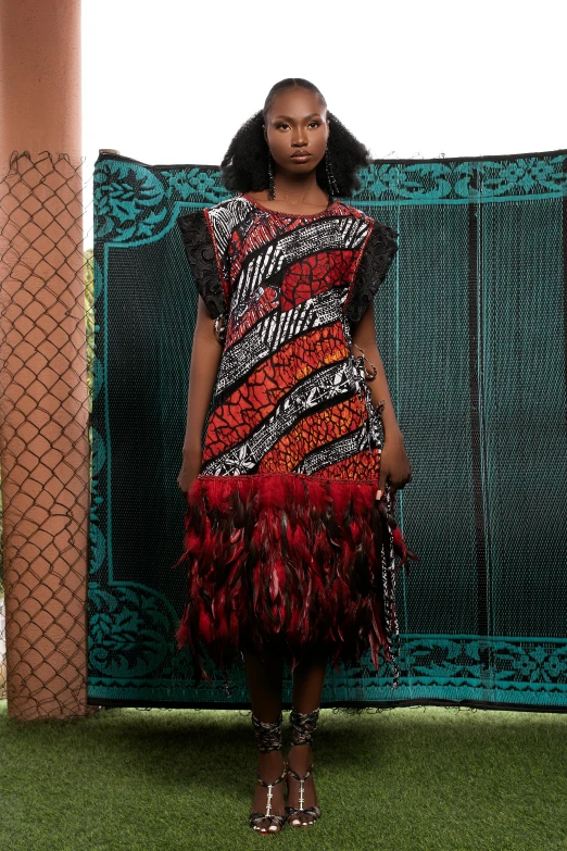 a model poses in a multicolored dress