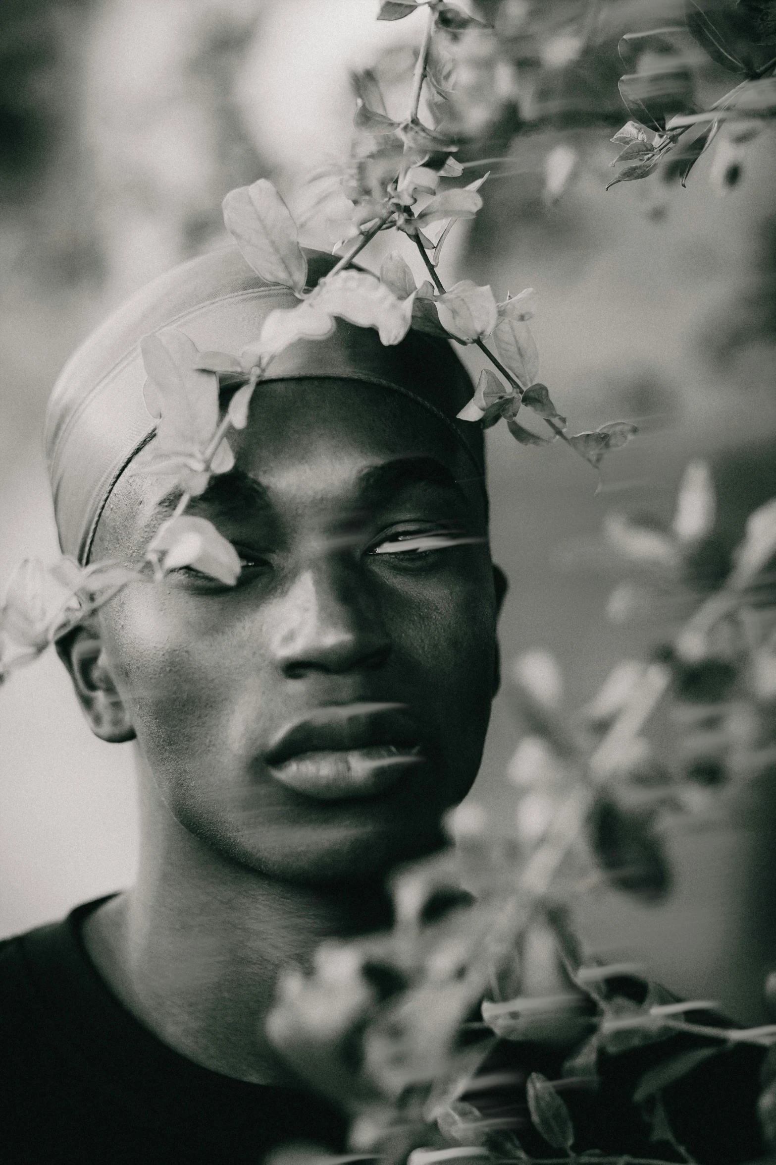 a black man with a flower on his head