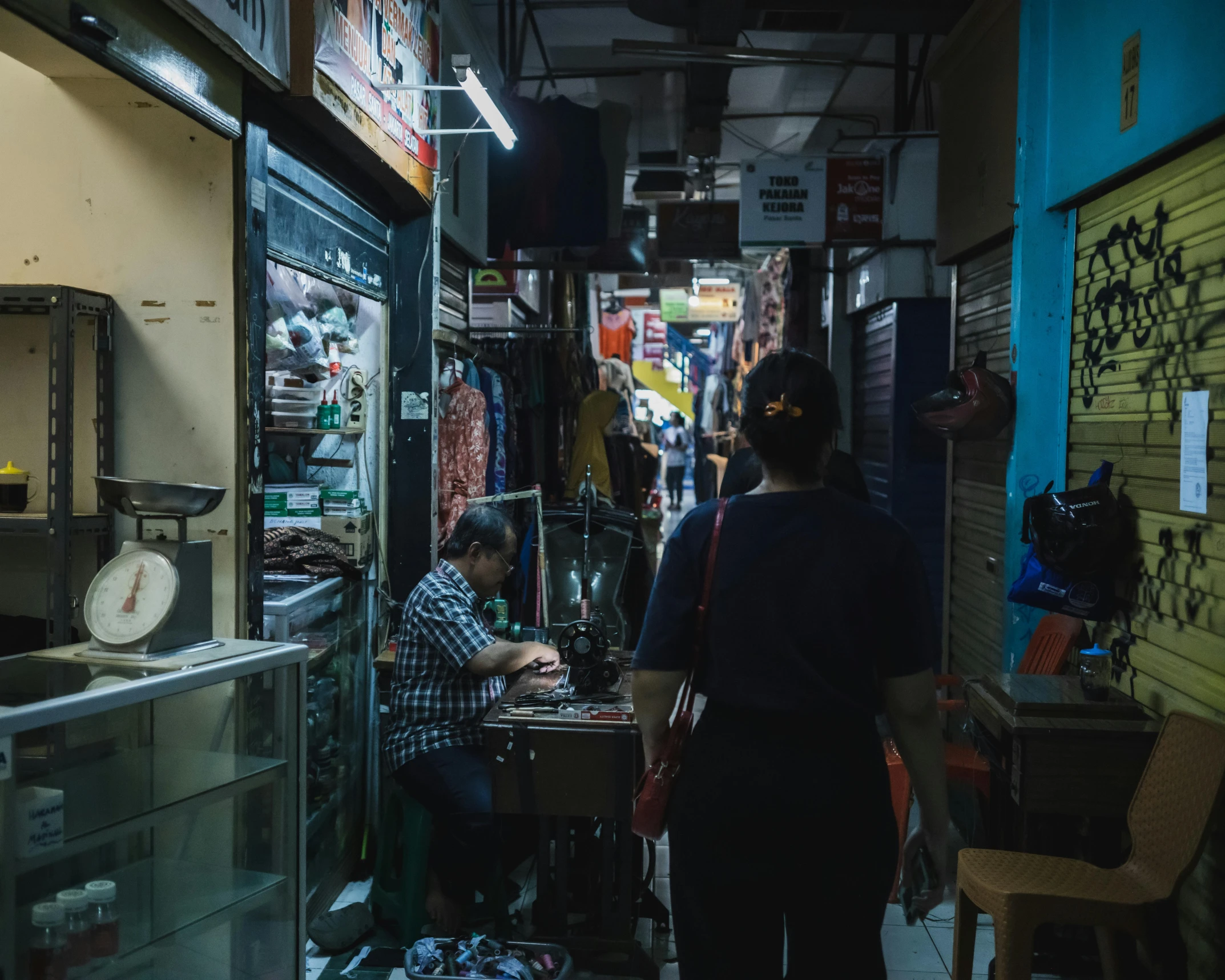 a man sits at a barber shop looking in the mirror