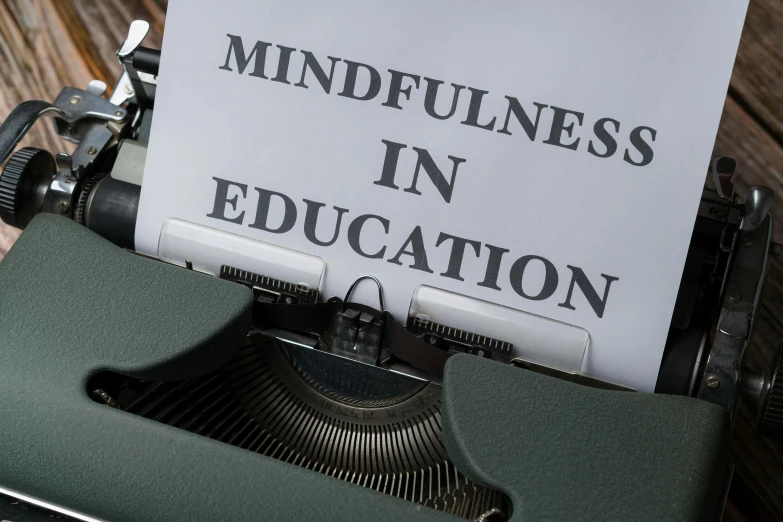 an old typewriter with a sign that says mindfulness in education