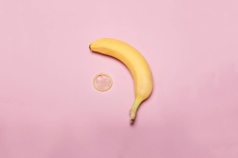 the banana is sitting next to the glass circle