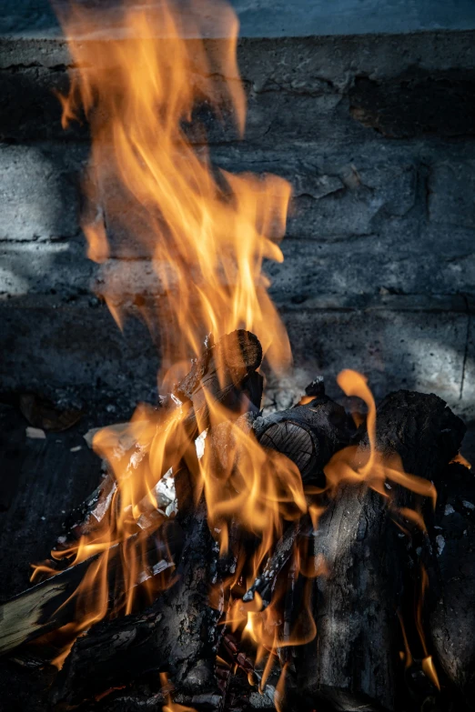 a close up of fire with rocks and logs