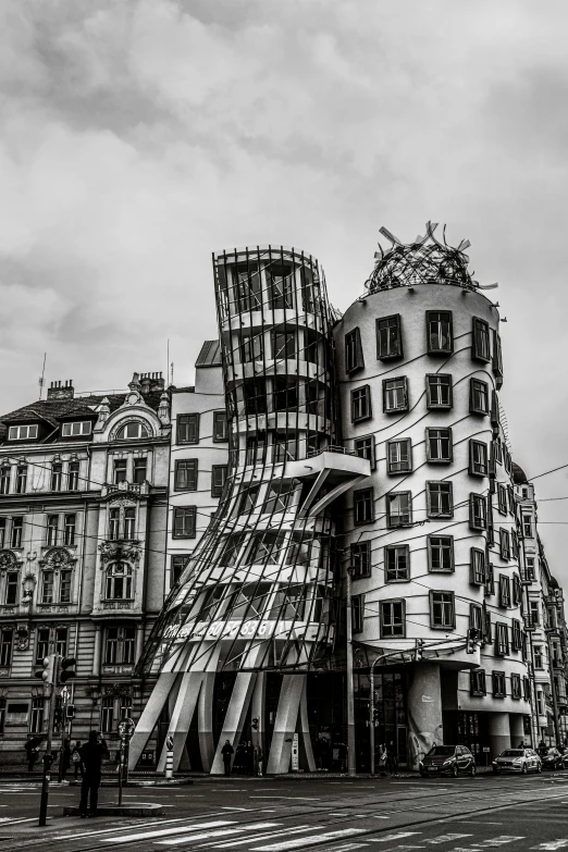 two people walking in front of the building on a cloudy day