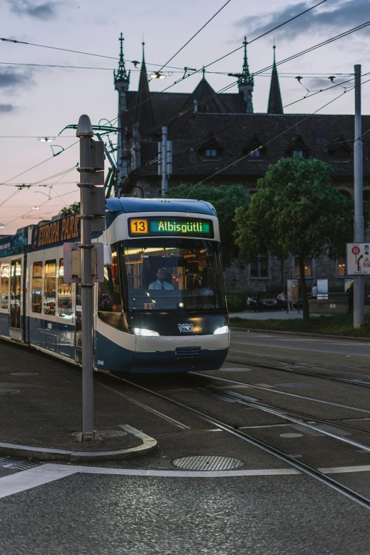 the trolley is coming down the tracks next to a sign