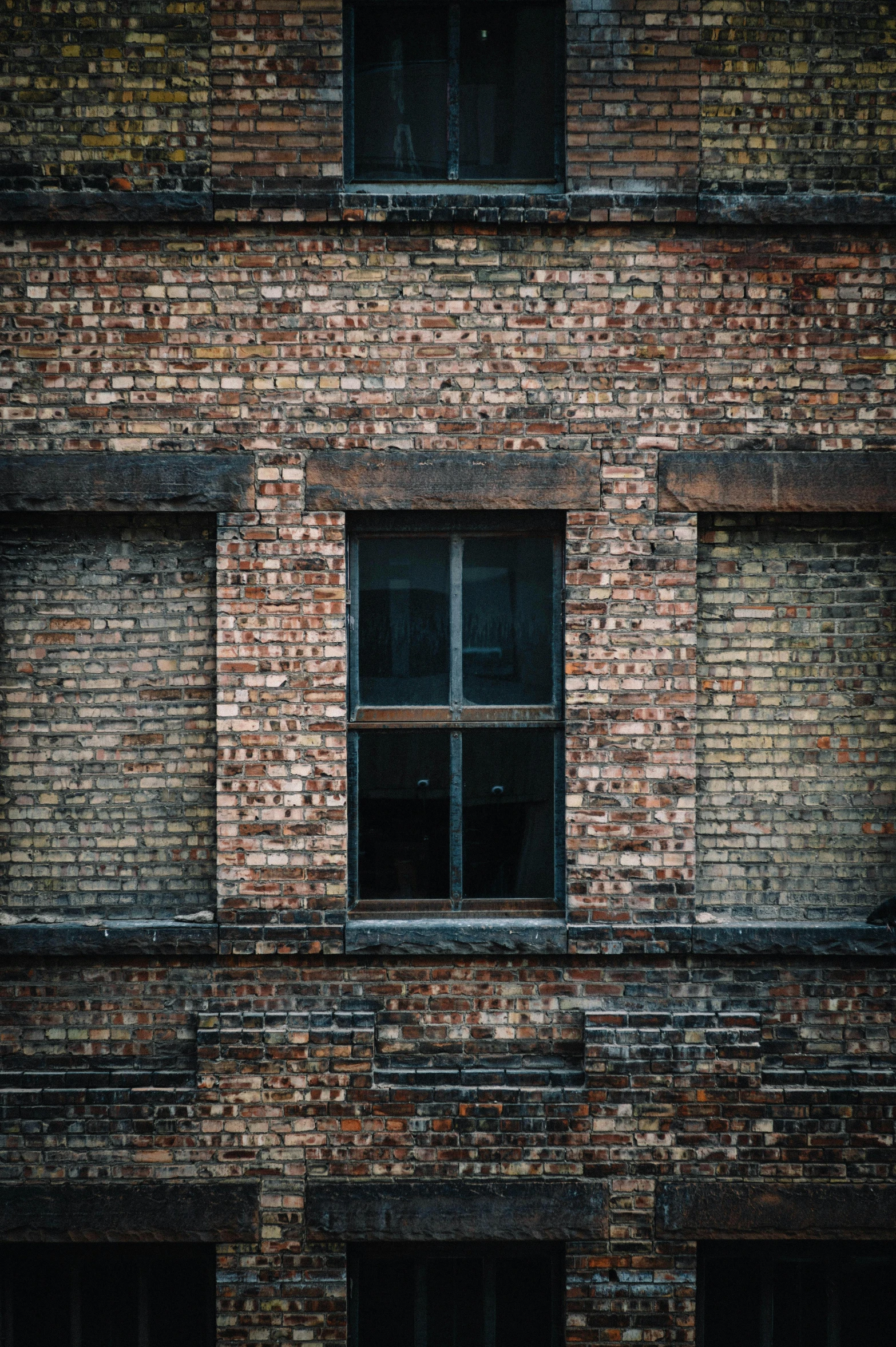 a brick building with windows and lots of wooden stairs