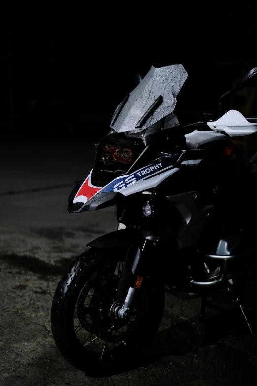 a black and white motorcycle parked on top of the street