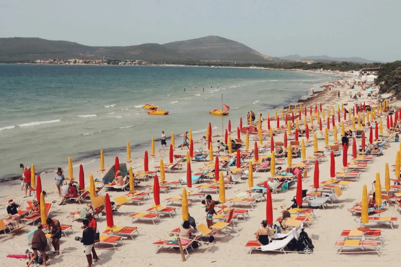 a beach that is full of orange umbrellas