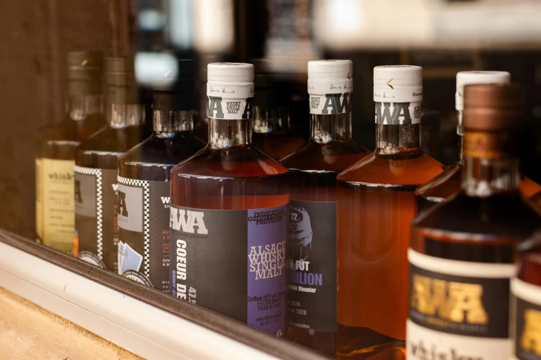 bottles are displayed on a window sill near a mirror