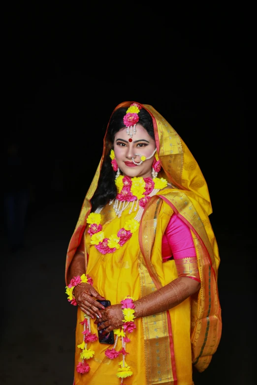 a woman in a yellow and red dress is dressed in a veil