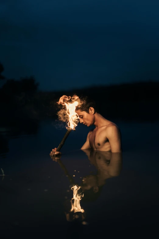 a man holding onto a stick in the water