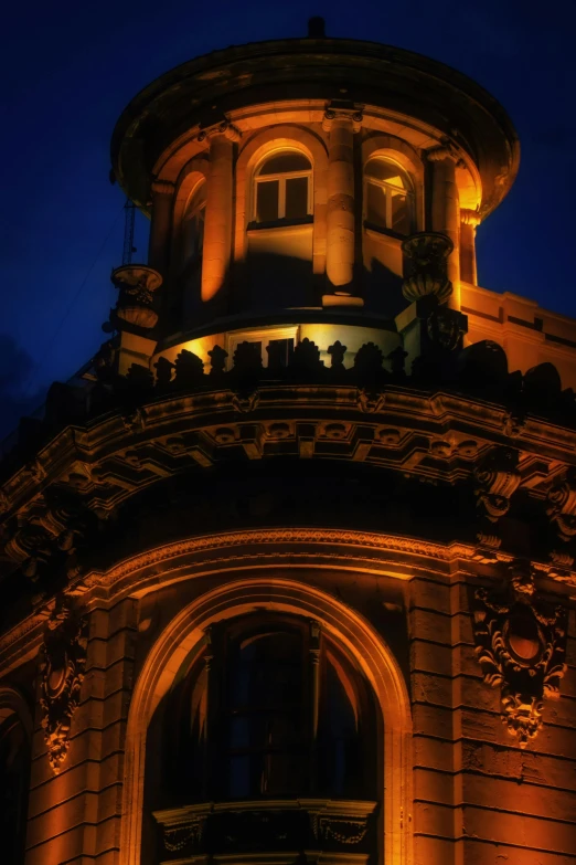 a tall tower with a clock and statues on top