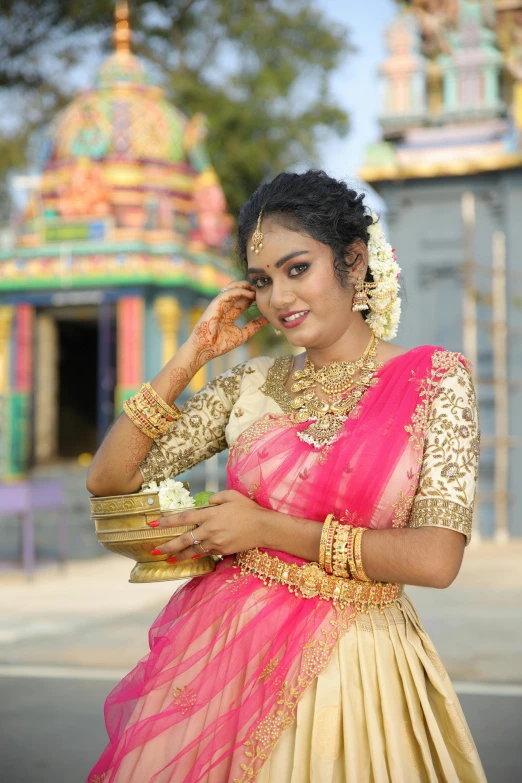 indian woman in traditional costume with her hand on her temple