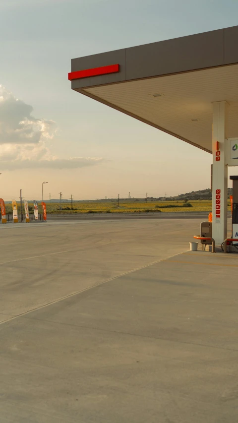 an empty gas station with a man on the ground