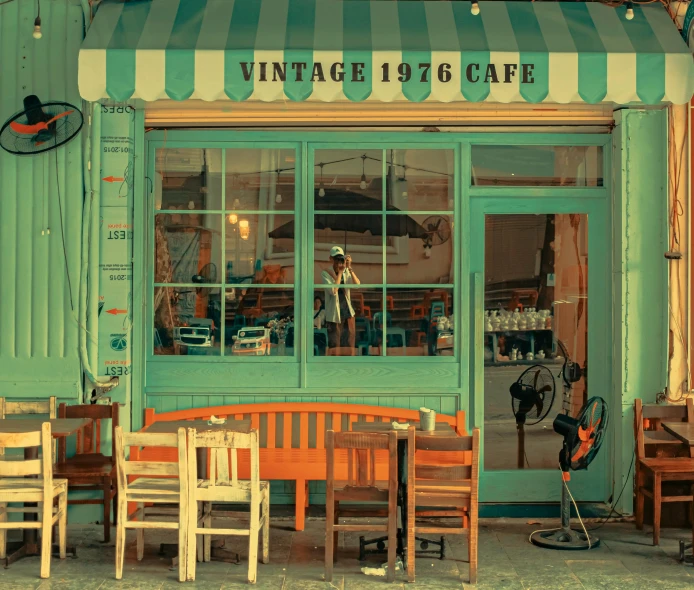 the store front of the old time restaurant with tables and chairs