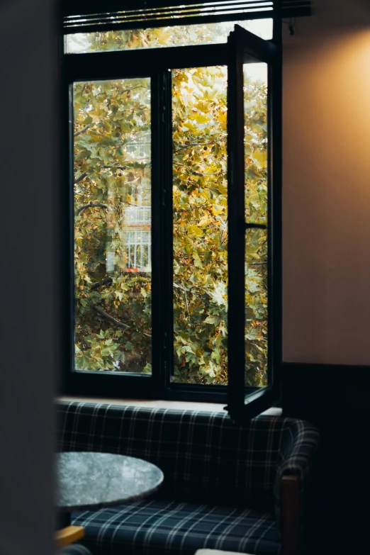 a room with a couch and chair looking outside