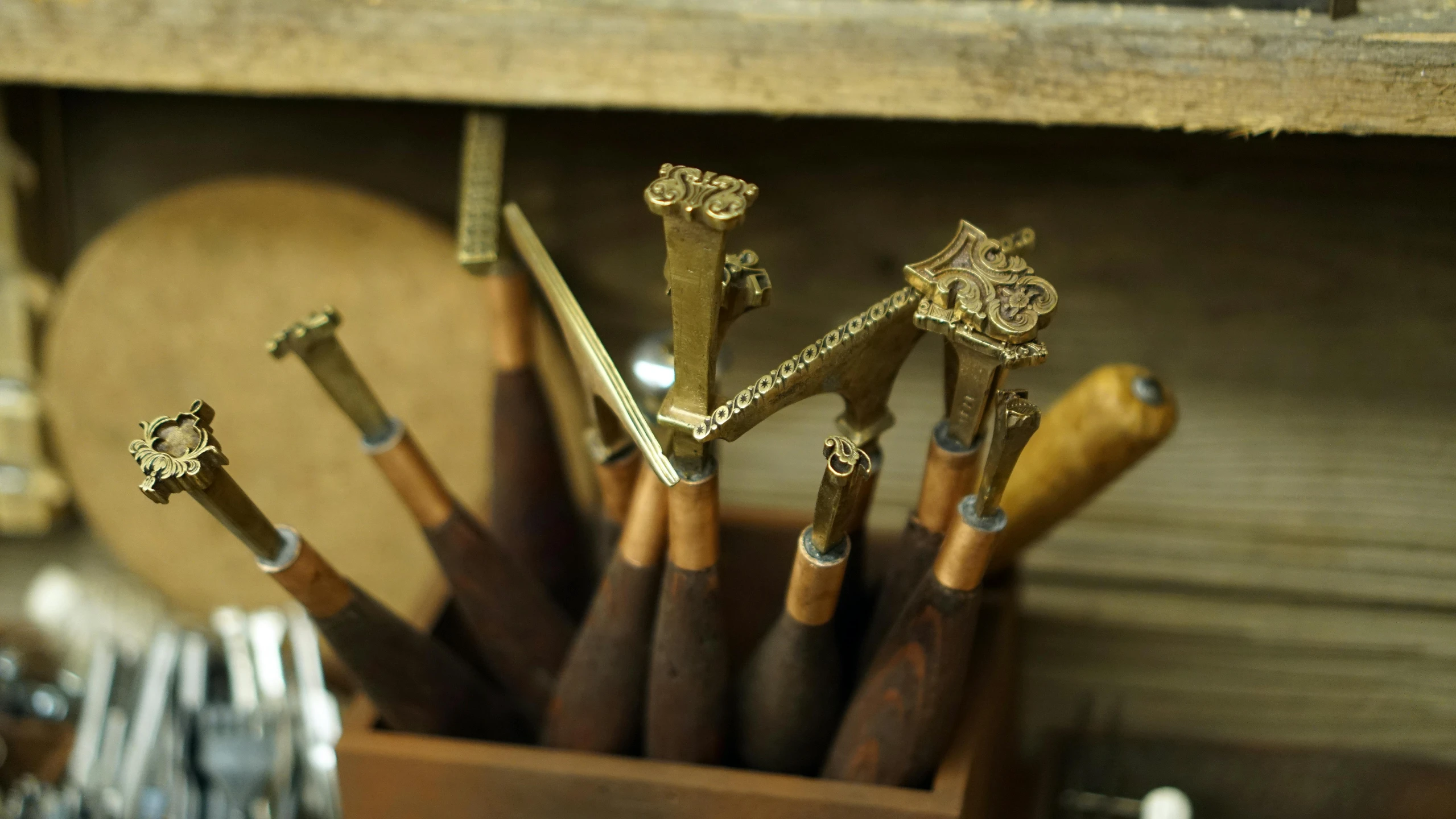 a bunch of metal spoons and small wooden objects