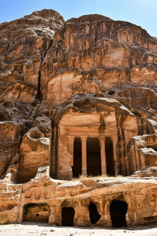 a large rocky structure with two small door holes