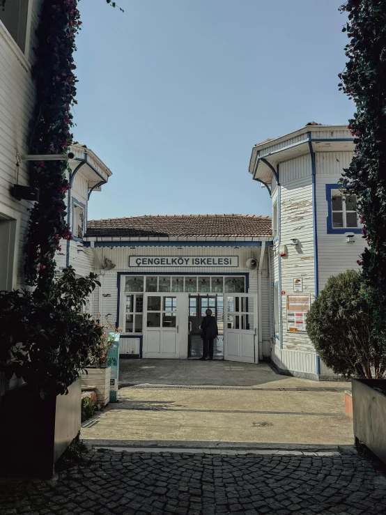 two doors are open on a street that leads to a building