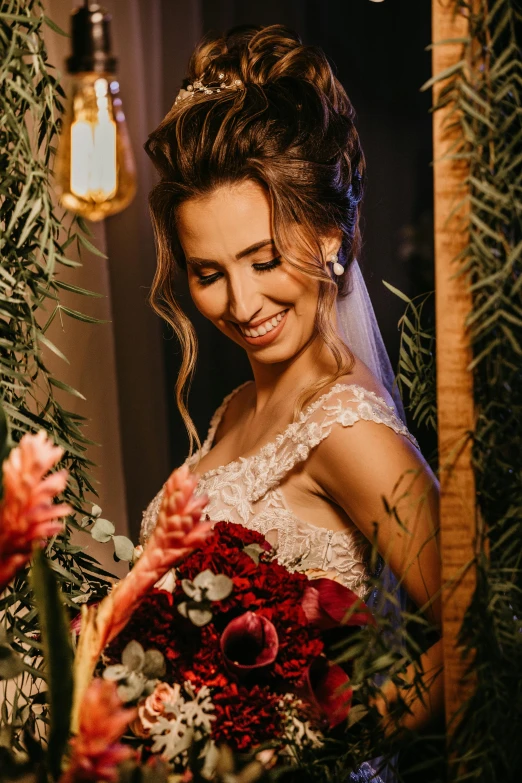 a smiling bride looking down while standing behind her