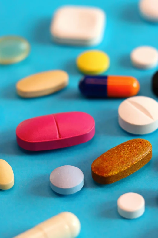 assortment of colorful pills sitting next to each other