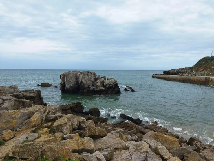 some rocks near a body of water with waves