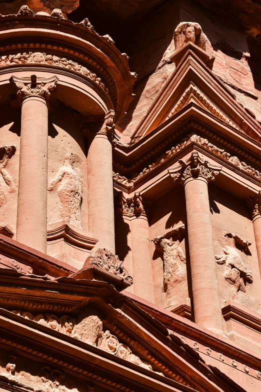 a tall church with carved faces on the front