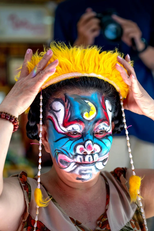 an image of a person with painted face and beads on