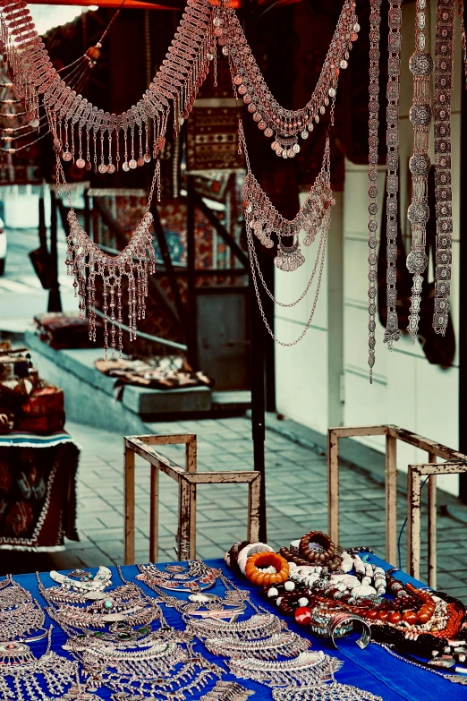 a blue table covered in lots of beads and other items