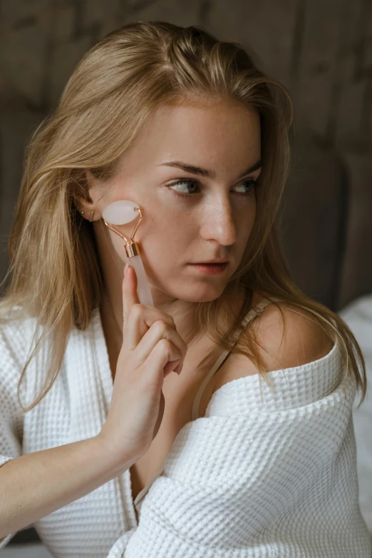 woman looking at a pair of earrings on her ear