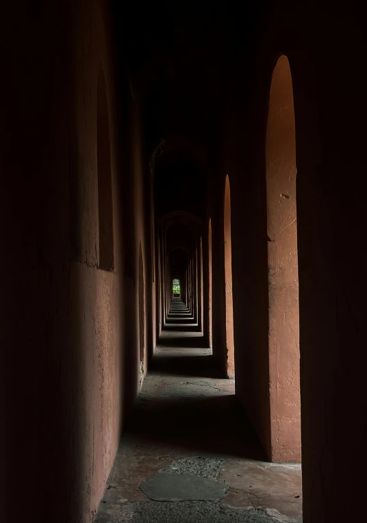 long tunnel of stone arches in an old building