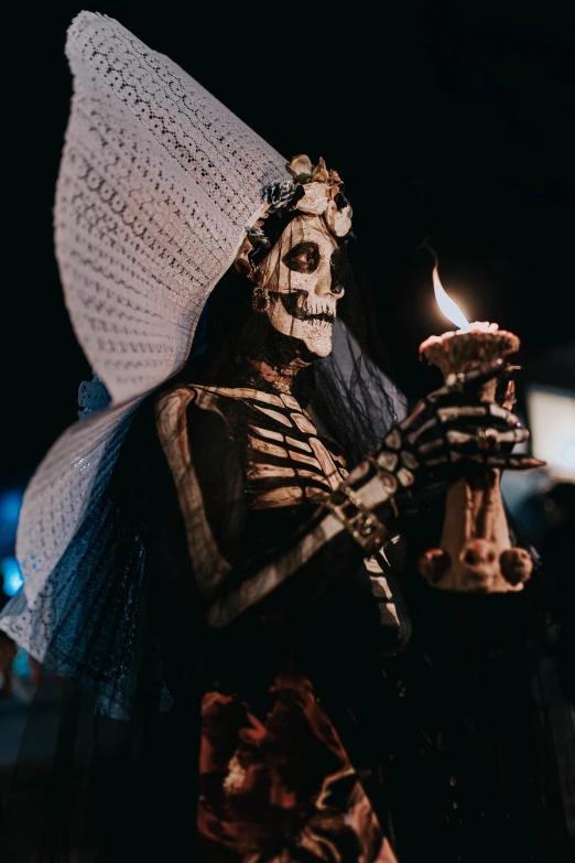 a skeleton holding a candle in it's hand