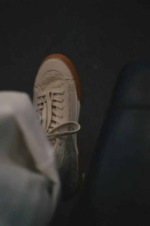 a white sneakers on top of a black seat