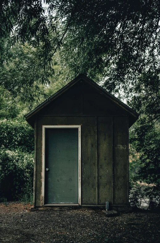 an outhouse is shown next to some trees