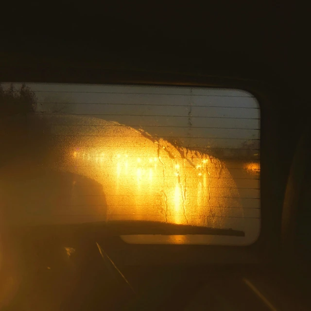 the back window of a car in the middle of night