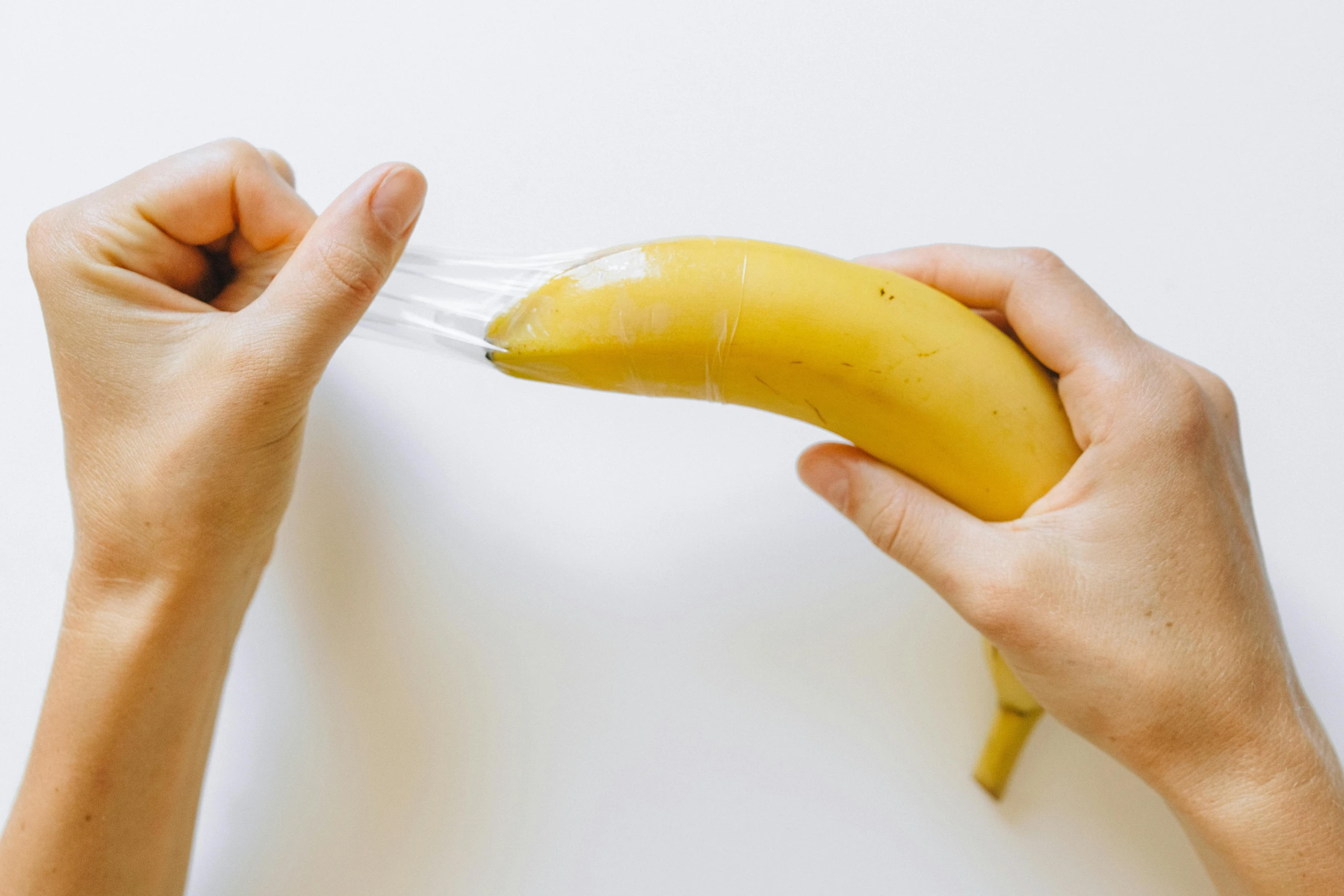 a person holding a banana in the middle of their hand