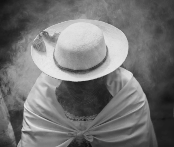 a woman with a white hat covering her face