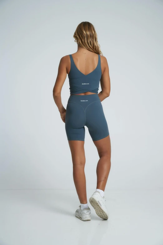woman in grey yoga suit back view