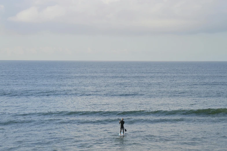 a person riding on top of a surfboard in the ocean