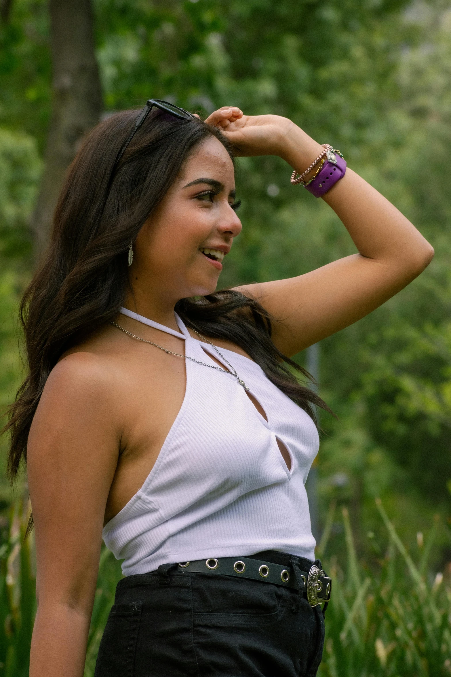 a girl wearing a white top in the woods